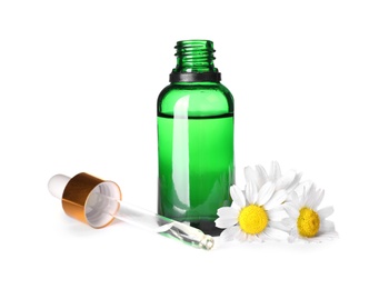 Photo of Bottle of chamomile essential oil, pipette and flowers isolated on white