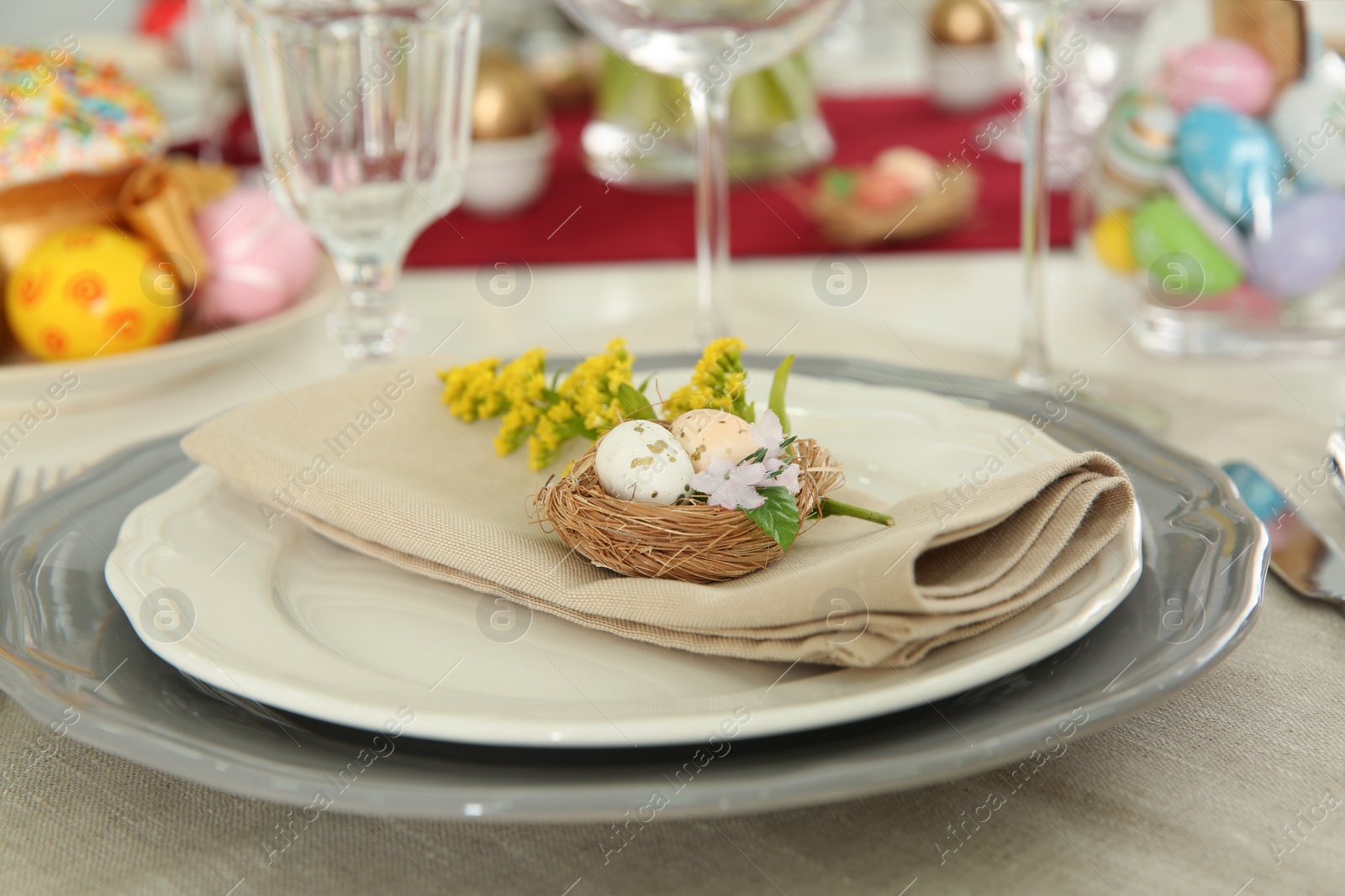 Photo of Festive Easter table setting with floral decor, closeup