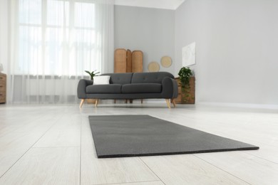 Photo of Grey yoga mat on floor in room