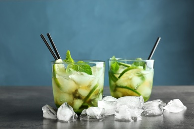 Photo of Delicious mint julep cocktail in glasses on table