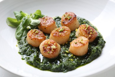 Photo of Delicious fried scallops with tasty sauce and corn salad in bowl, closeup