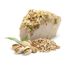 Image of Tasty halva with pistachios, peeled sunflower seeds and green leaves isolated on white