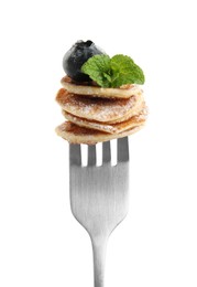 Photo of Fork with cereal pancakes, blueberry and mint on white background