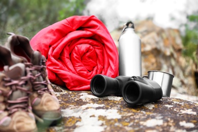 Photo of Rolled sleeping bag and other camping gear outdoors