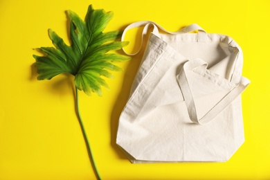 Photo of Flat lay composition with eco tote bag and leaf on color background