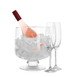 Bottle of rose champagne in vase with ice and flutes on white background