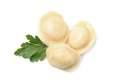 Boiled dumplings with parsley on white background, top view