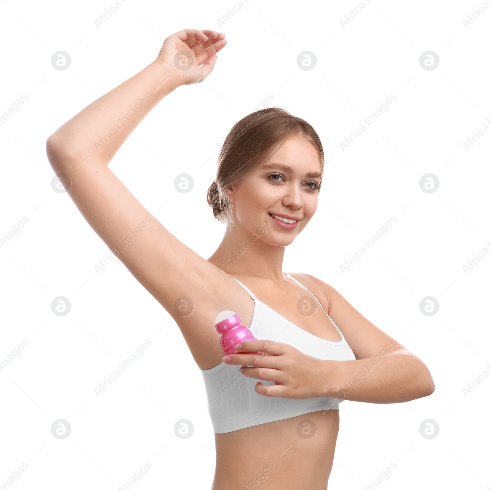 Photo of Young woman applying deodorant to armpit on white background