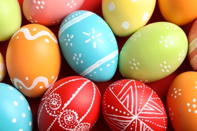 Colorful decorated Easter eggs as background, top view