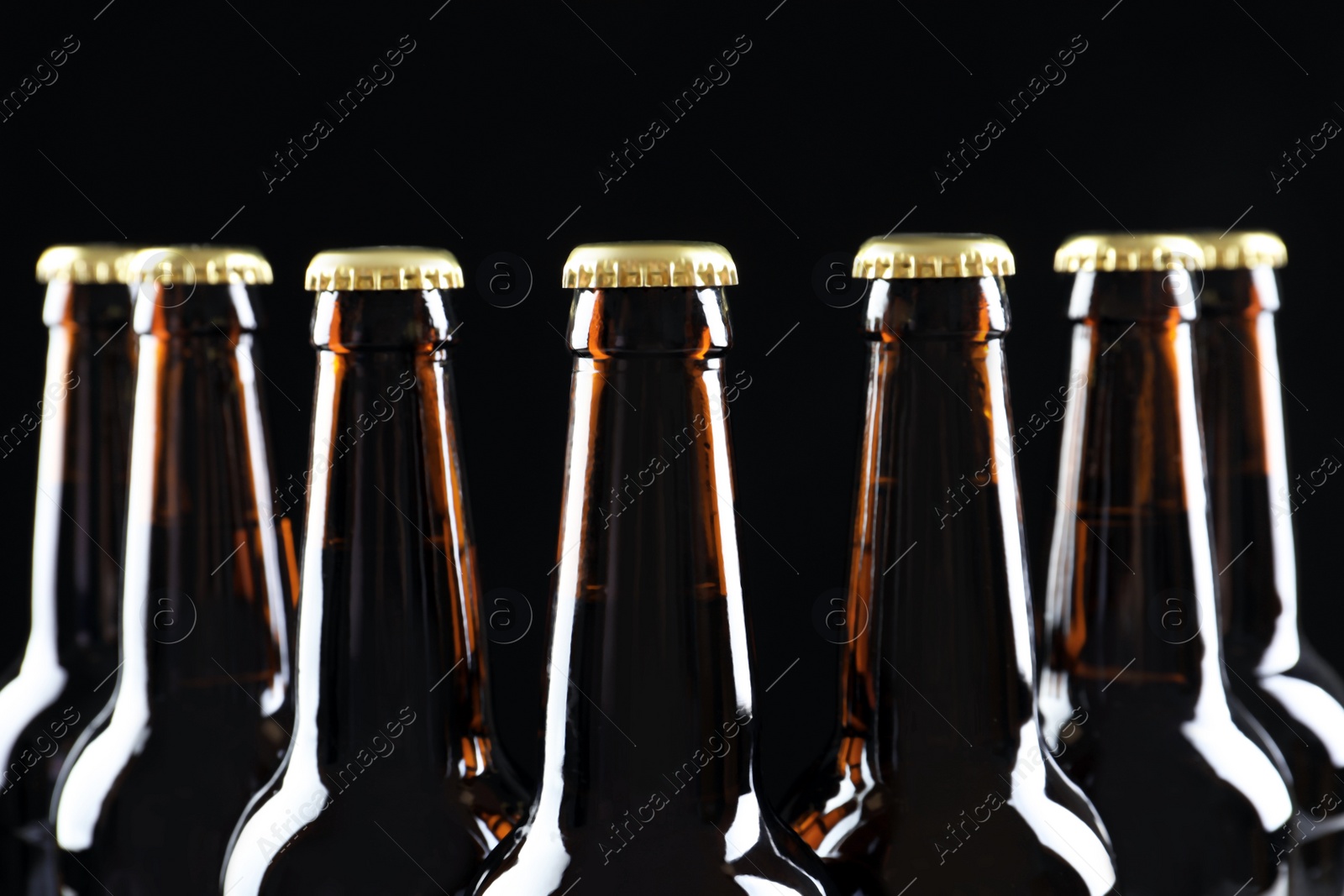 Photo of Many bottles of beer on dark background