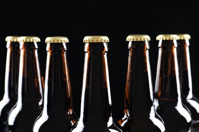 Photo of Many bottles of beer on dark background