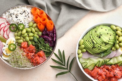 Delicious poke bowls with vegetables, fish and edamame beans on light table, flat lay