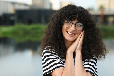 Photo of Portrait of beautiful woman in glasses outdoors. Attractive lady smiling and posing for camera. Space for text