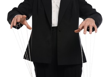 Photo of Woman in suit pulling strings of puppet on white background, closeup