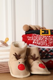 Baby Christmas clothes and accessories on wooden table