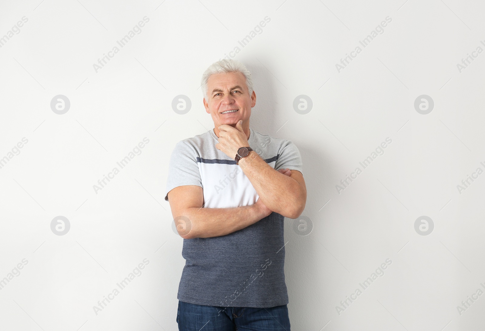 Photo of Portrait of handsome mature man on light background