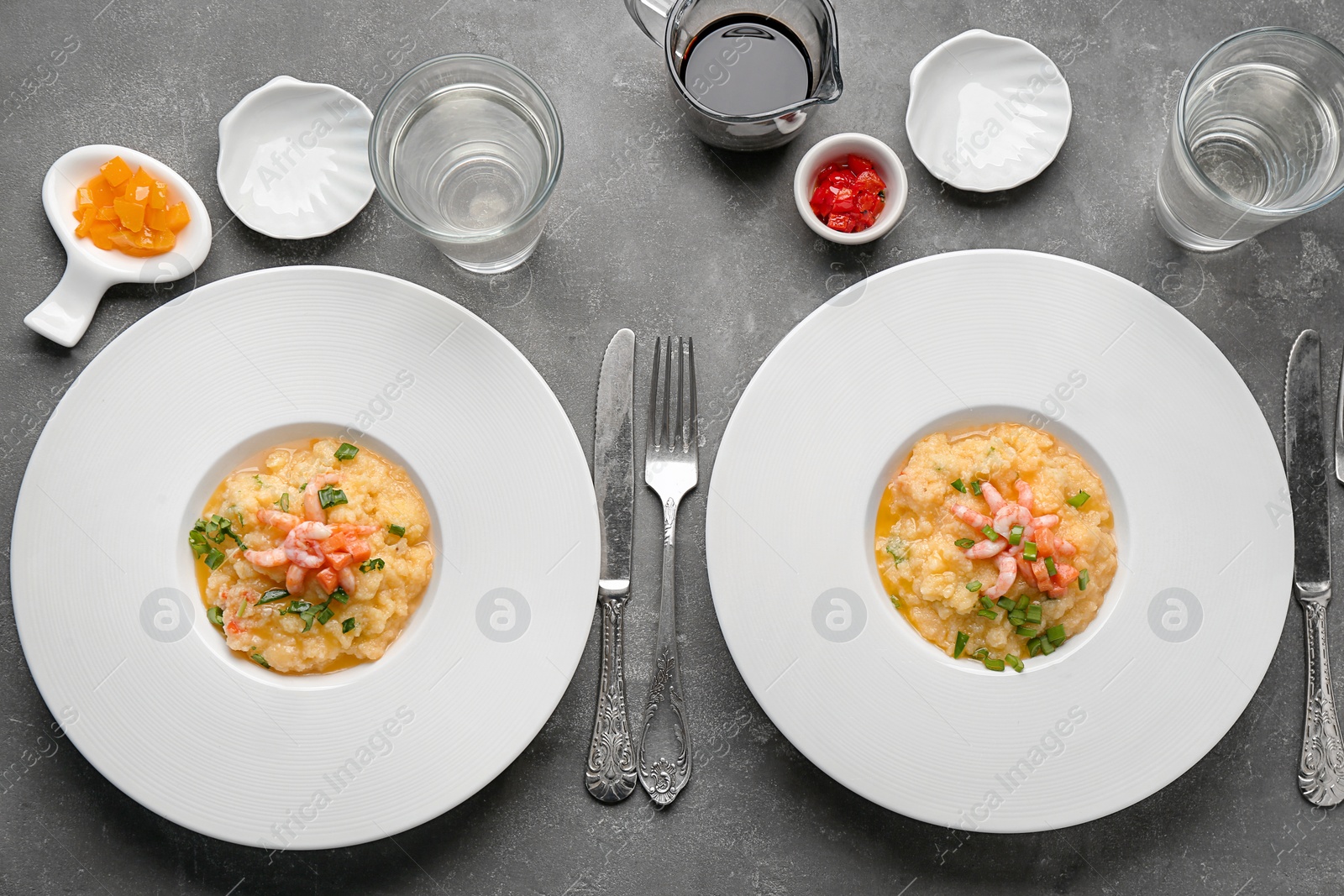 Photo of Plates with tasty shrimps and grits on table, top view