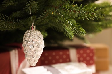 Beautiful Christmas bauble on fir tree branch, closeup