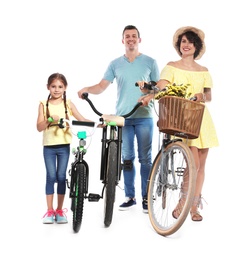 Portrait of parents and their daughter with bicycles on white background