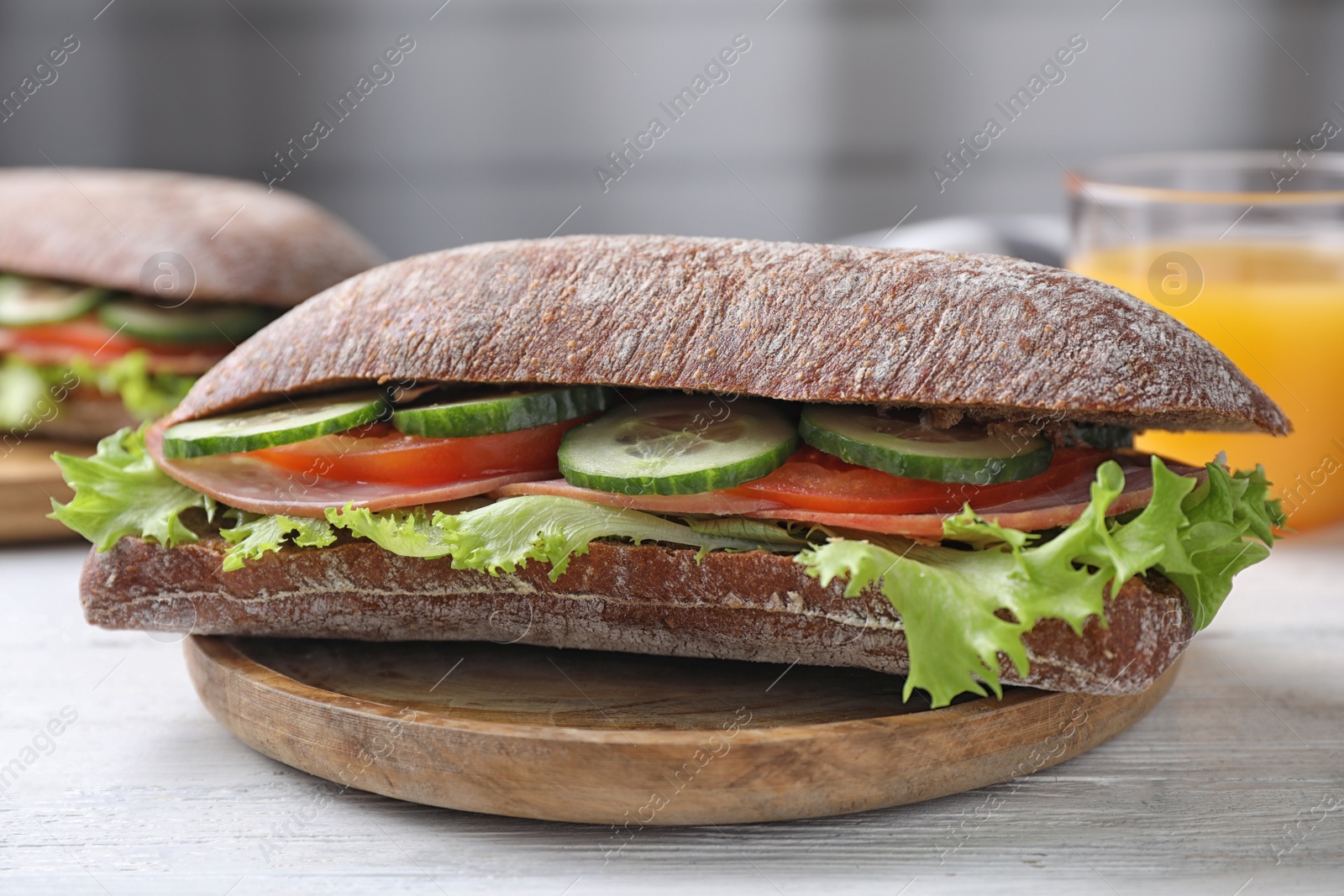 Photo of Tasty sandwich with ham on white wooden table