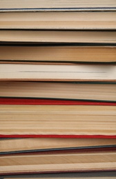 Photo of Stack of hardcover books as background, closeup