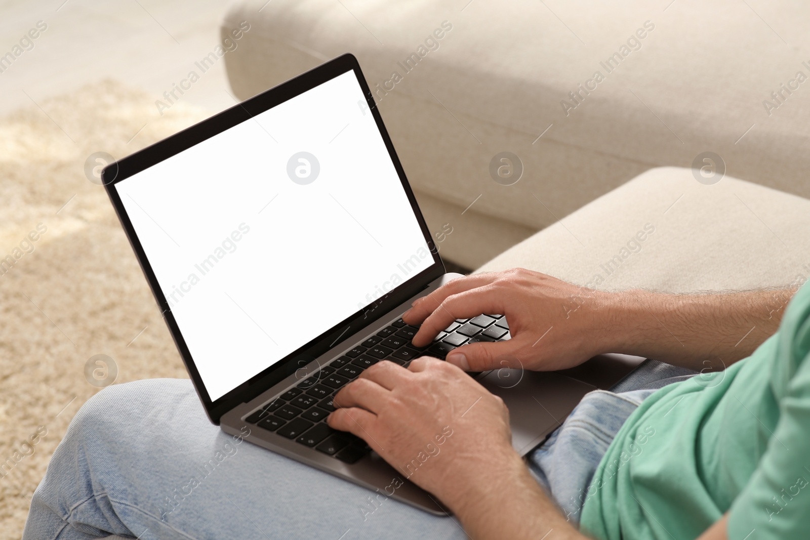 Photo of Man using laptop at home, closeup view