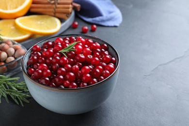 Photo of Fresh ripe cranberries and spices on grey table. Space for text