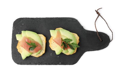Delicious crackers with avocado, prosciutto and parsley on white background, top view