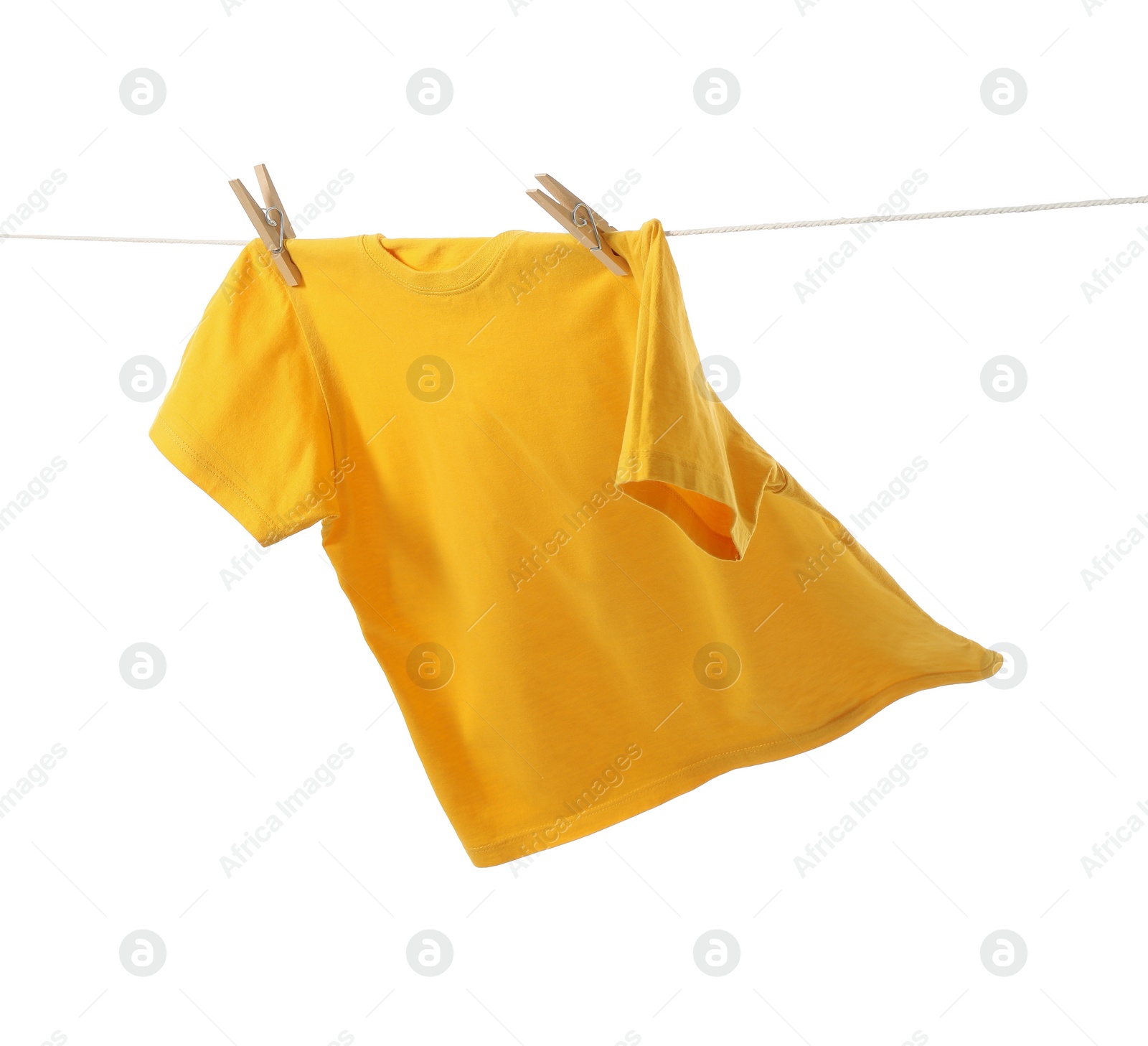 Photo of One yellow t-shirt drying on washing line isolated on white