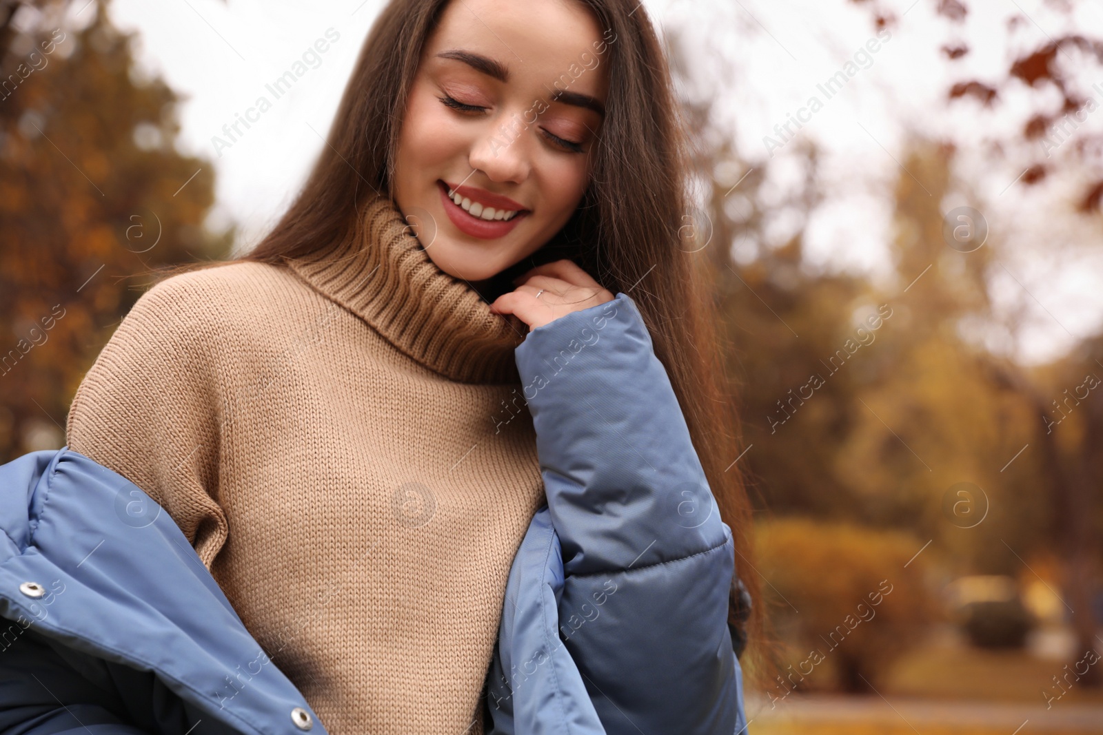 Photo of Young woman wearing stylish clothes in autumn park