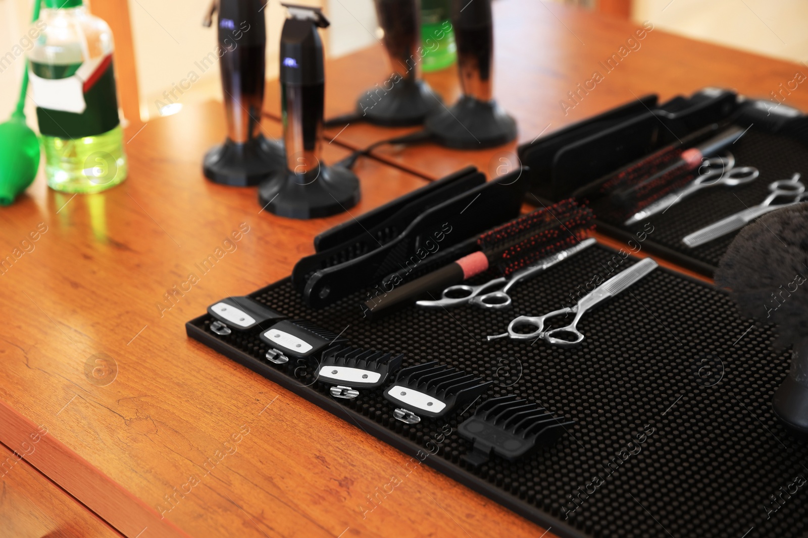 Photo of Stylish hairdresser's workplace with professional tools in barbershop, closeup