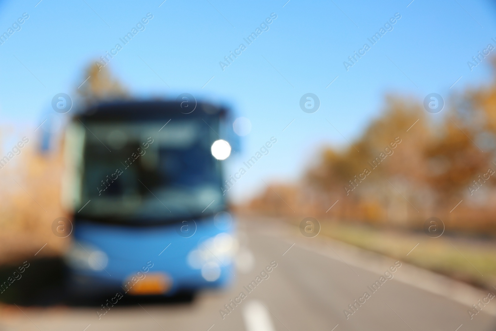 Photo of Blurred view of modern blue bus on road. Passenger transportation
