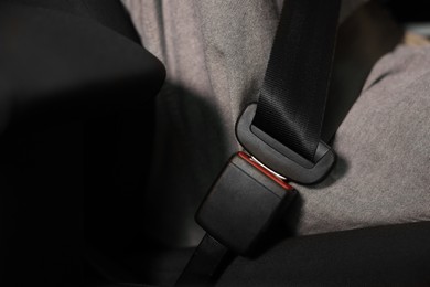 Photo of Fastened safety seat belt in car, closeup
