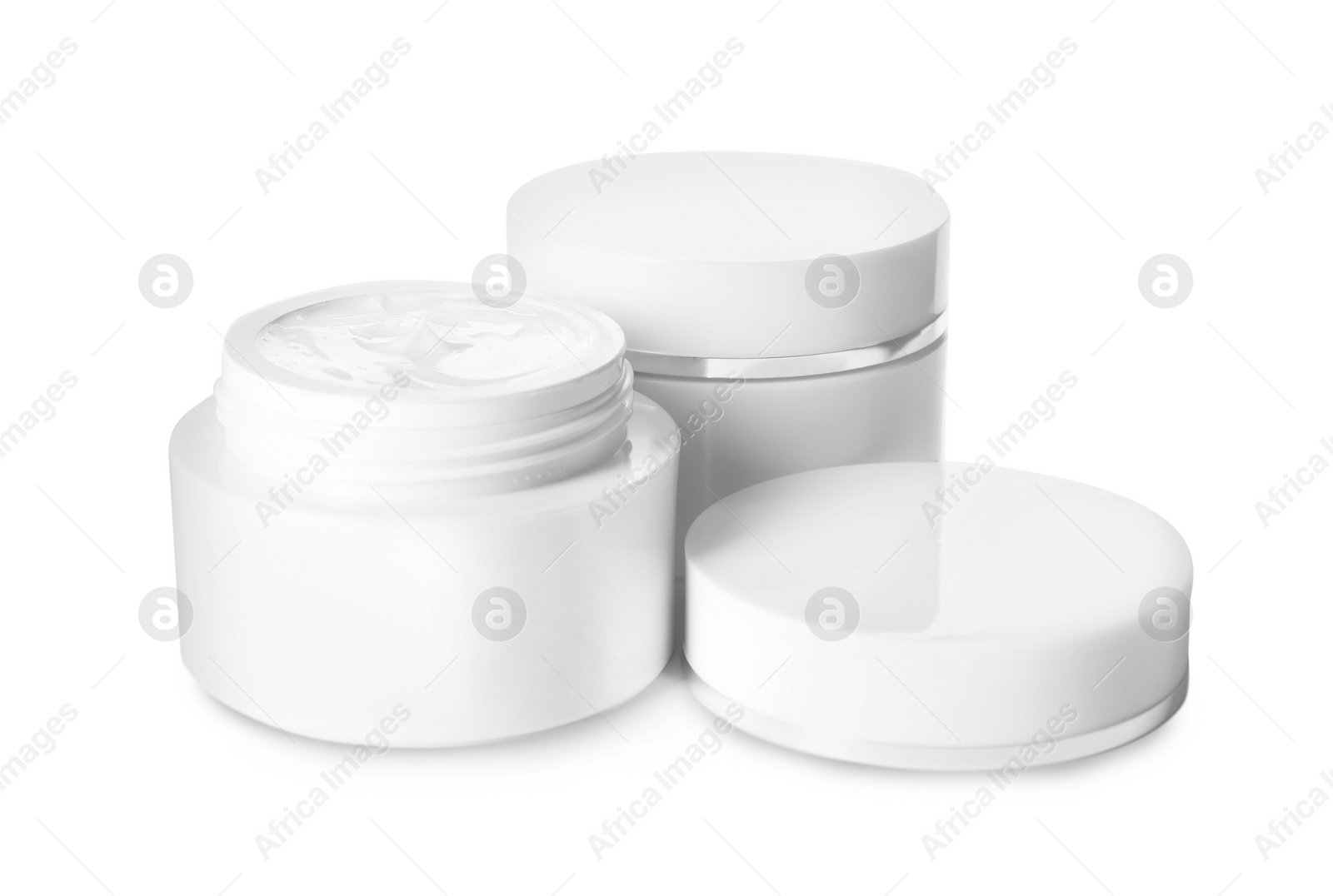 Photo of Jars of luxury face creams isolated on white