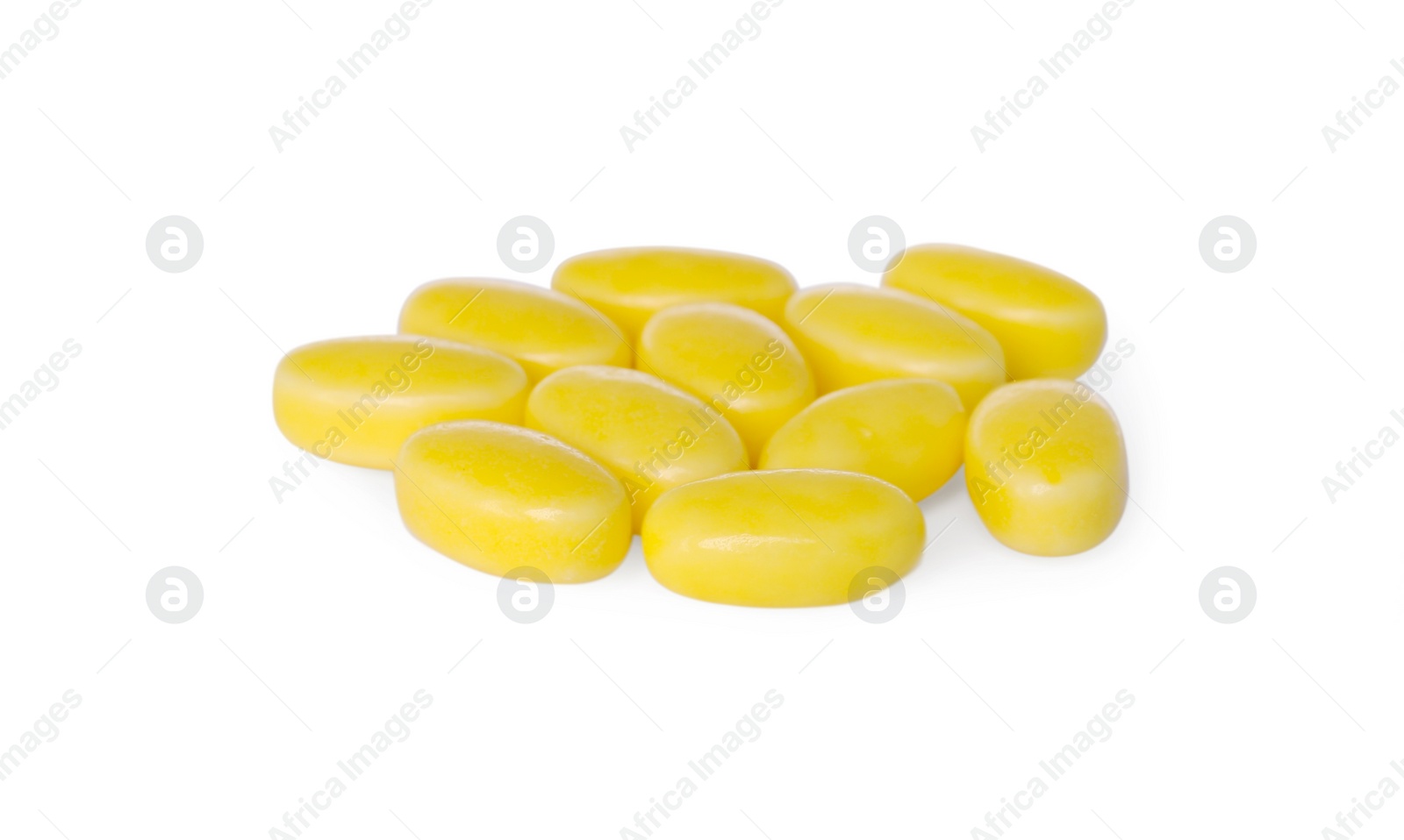 Photo of Tasty yellow dragee candies on white background