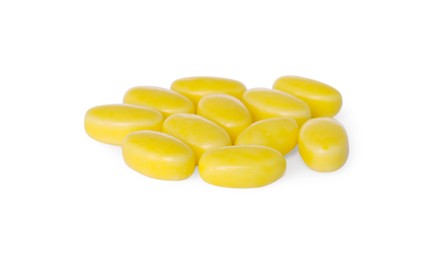 Tasty yellow dragee candies on white background