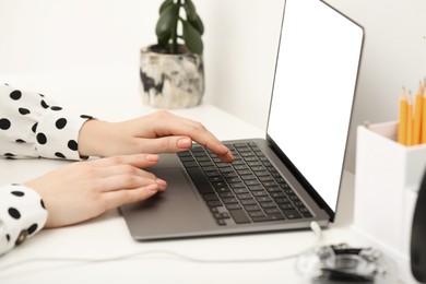 E-learning. Woman using laptop during online lesson at table indoors, closeup