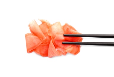 Chopsticks with pickled ginger on white background, top view