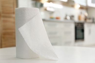 Photo of Roll of paper towels on table in kitchen, space for text