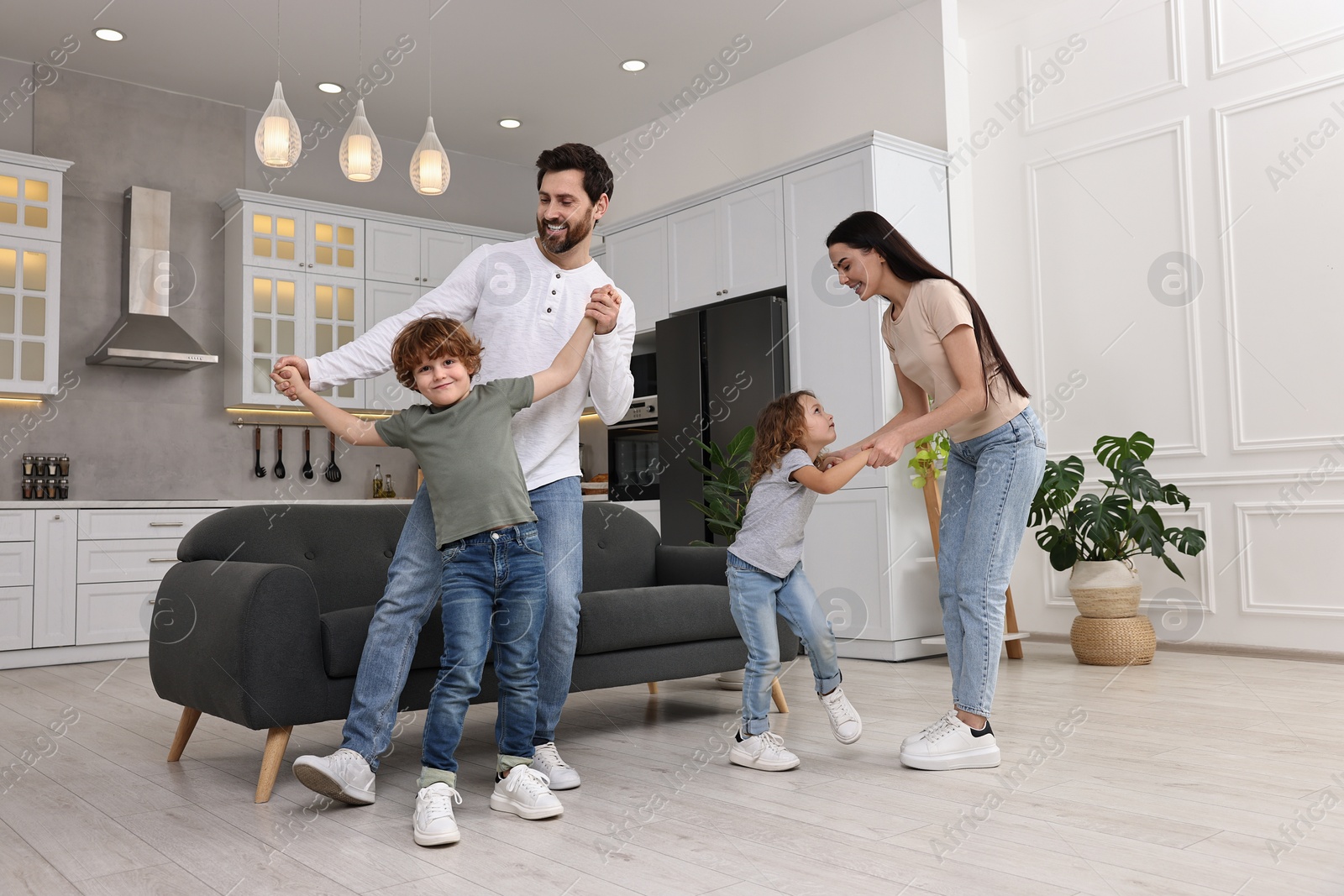 Photo of Happy family dancing and having fun at home, low angle view