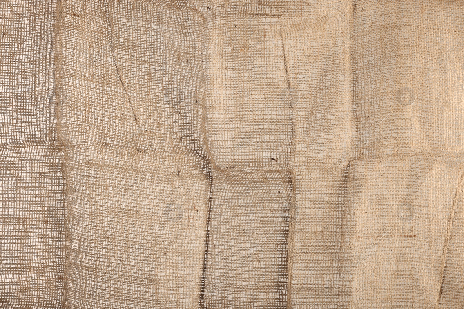 Photo of Texture of natural burlap fabric as background, closeup