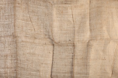 Photo of Texture of natural burlap fabric as background, closeup