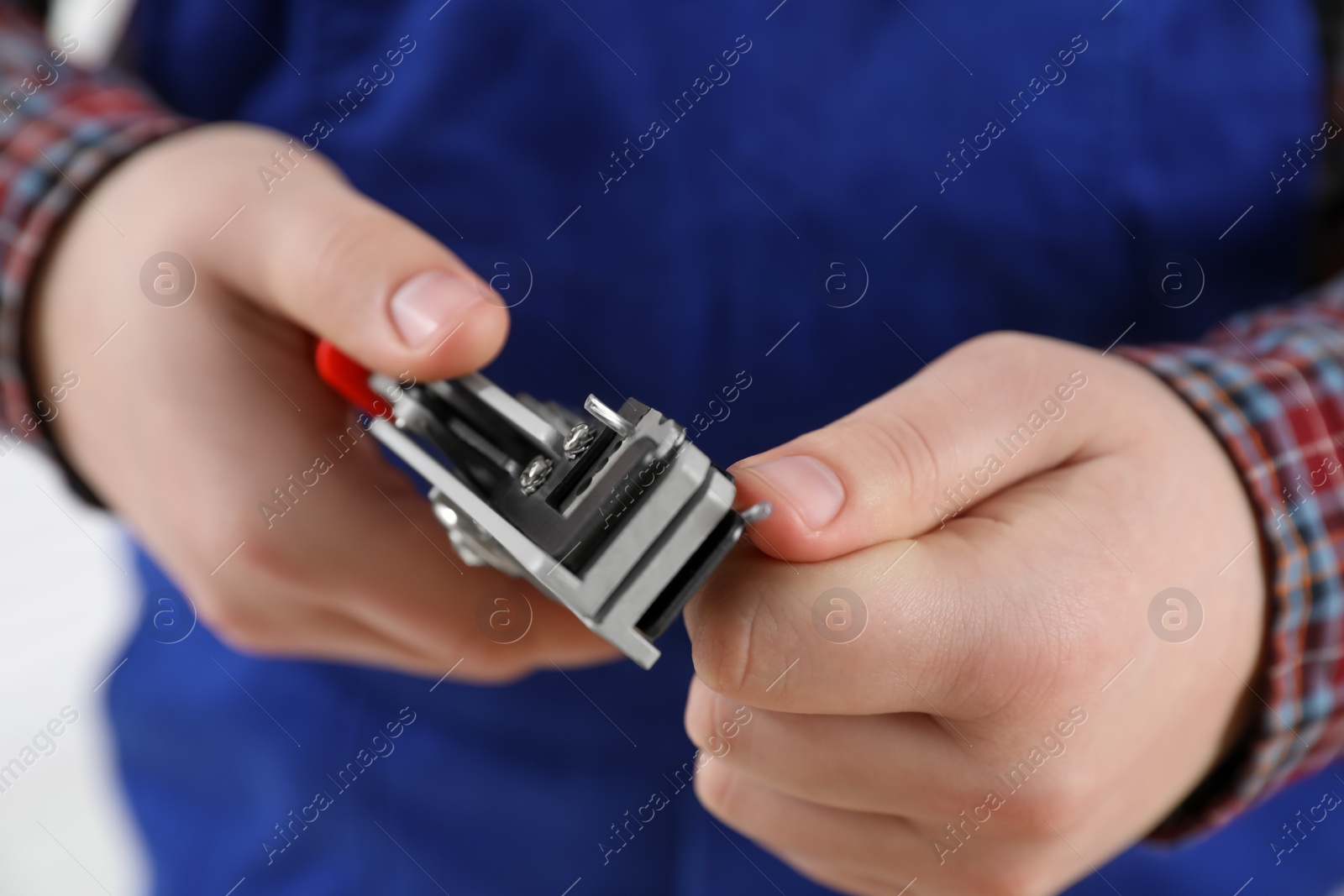 Photo of Professional electrician stripping wiring on white background, closeup