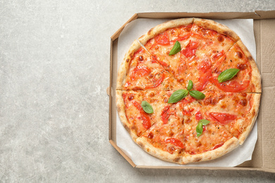 Photo of Delicious pizza Margherita on light grey table, top view. Space for text