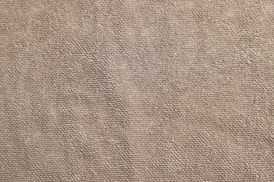 Soft brown towel as background, top view
