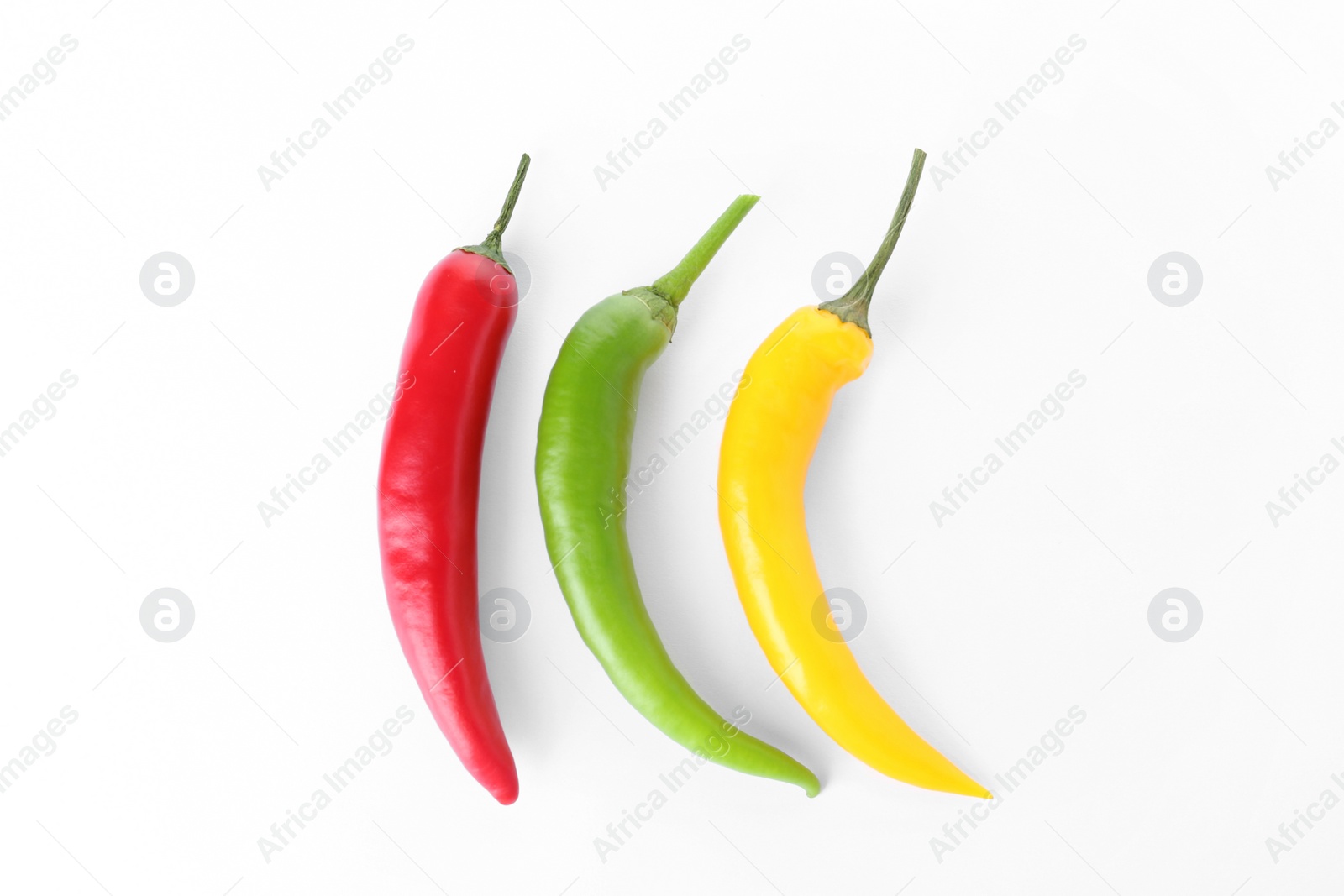 Photo of Ripe hot chili peppers on white background