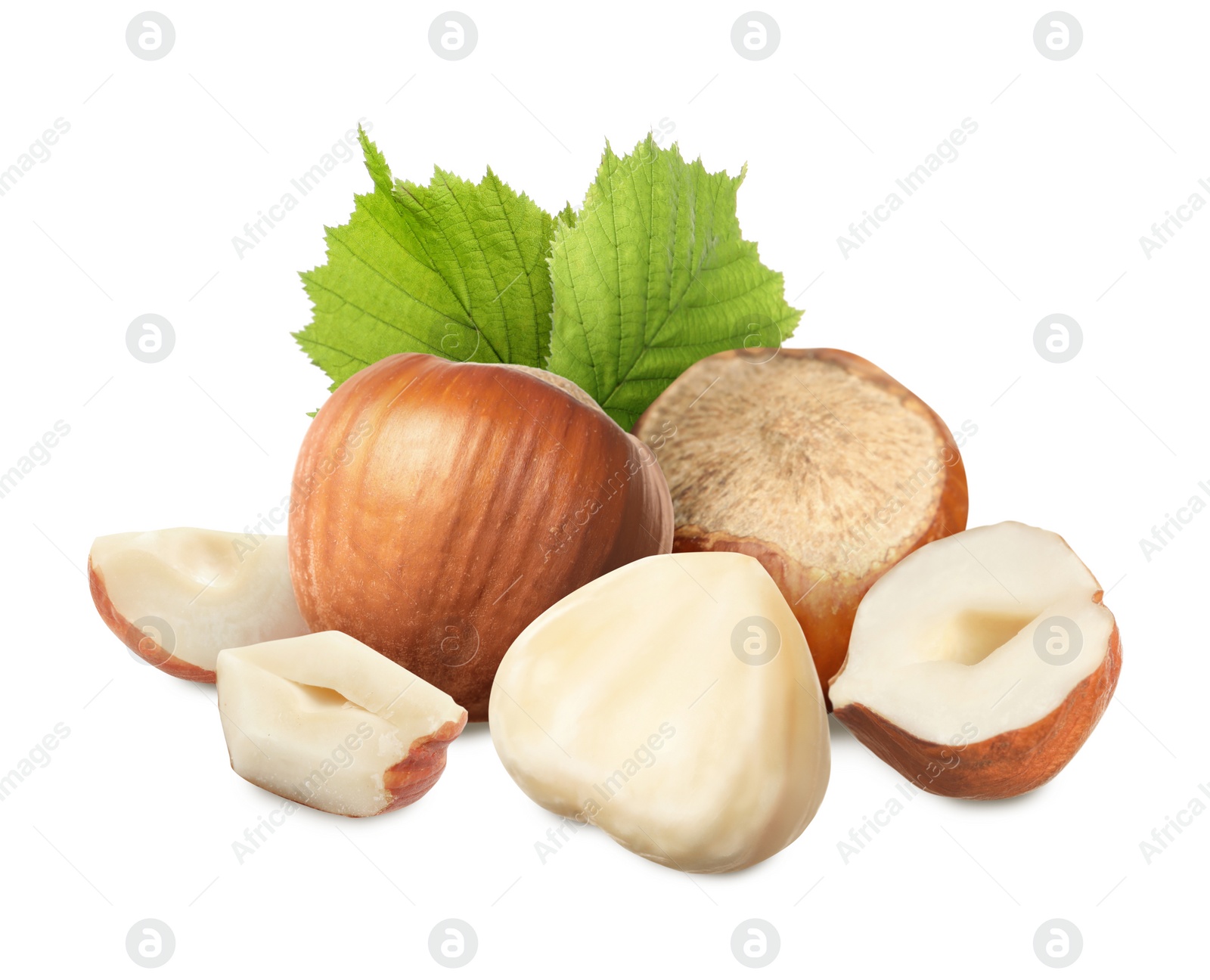 Image of Tasty hazelnuts and green leaves on white background