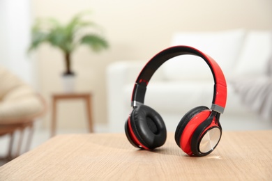 Photo of Stylish headphones on table indoors. Space for text