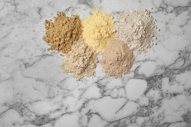 Photo of Composition with different types of flour on light background