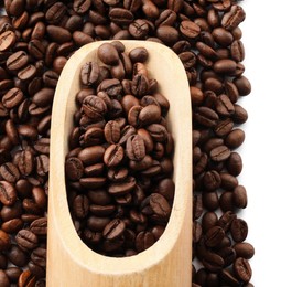 Wooden scoop with roasted coffee beans isolated on white, top view